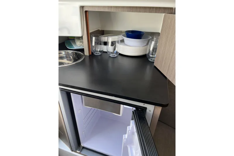 Slide: The Image of Interior of 2022 Beneteau Flyer 8 SUNdeck with open fridge and kitchenware. - 25