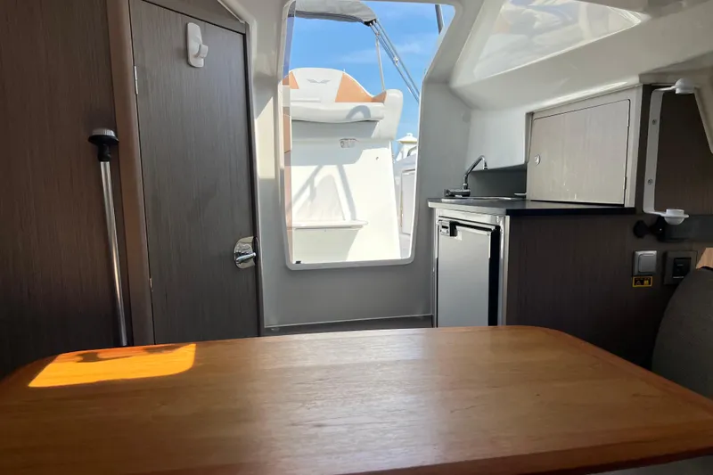 Slide: The Image of Interior view of 2022 Beneteau Flyer 8 SUNdeck, featuring kitchenette and seating area. - 29