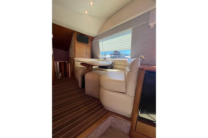 Slide: The Image of Interior of 2002 Ocean Yachts 56 Super Sport with plush seating and wooden accents. - 11