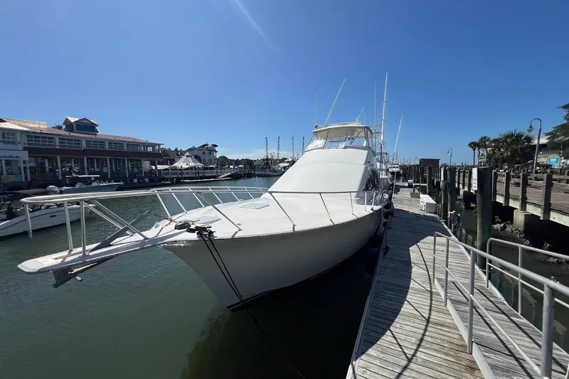 Slide: The Image of 2002 Ocean Yachts 56 Super Sport docked at a marina under clear blue skies. - 2