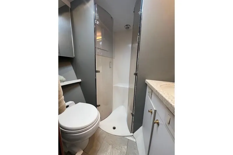 Slide: The Image of Bathroom interior of 2002 Ocean Yachts 56 Super Sport, featuring shower and toilet. - 24