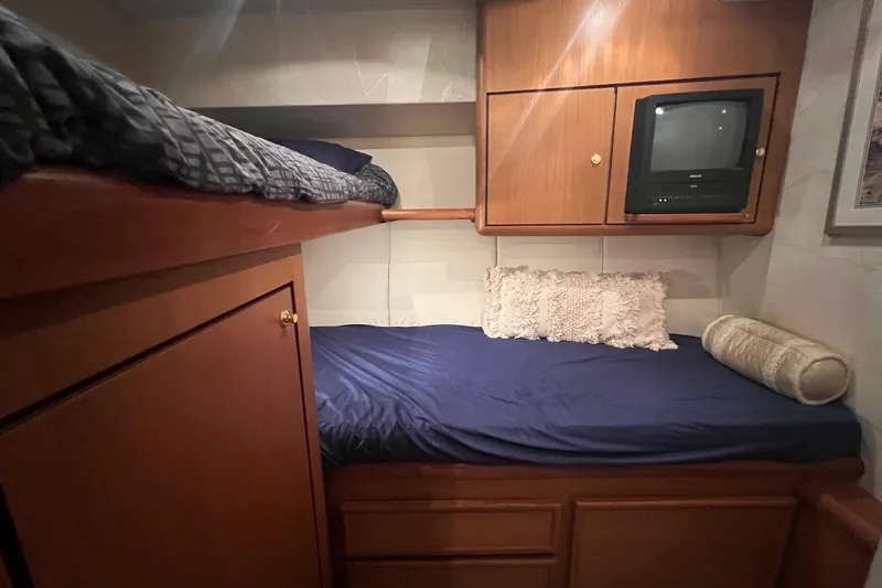 Slide: The Image of Cozy cabin interior of 2002 Ocean Yachts 56 Super Sport with bunk beds and TV. - 26