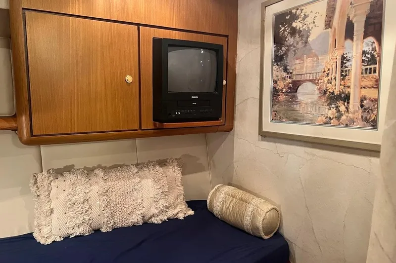 Slide: The Image of Cozy cabin interior of 2002 Ocean Yachts 56 Super Sport with TV and artwork. - 27