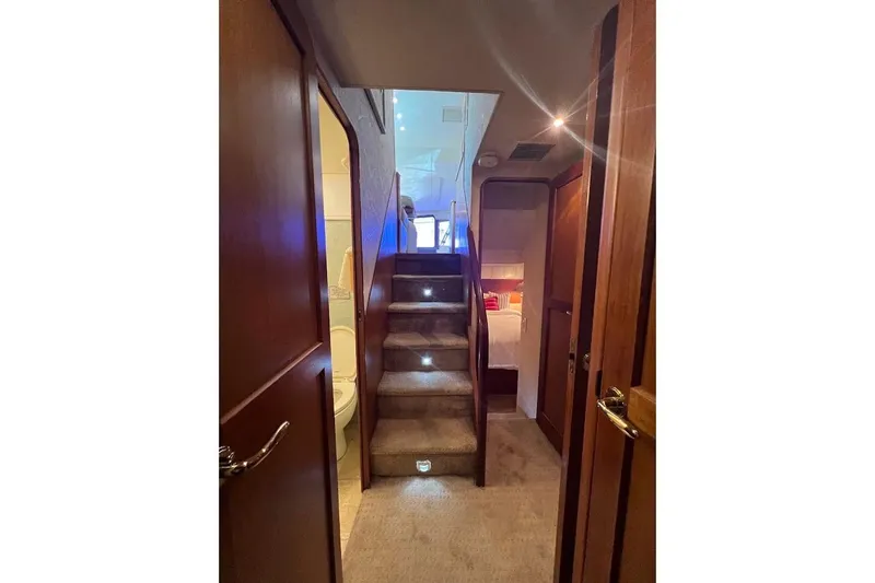 Slide: The Image of Interior of 2002 Ocean Yachts 56 Super Sport, featuring carpeted stairs and wooden doors. - 31