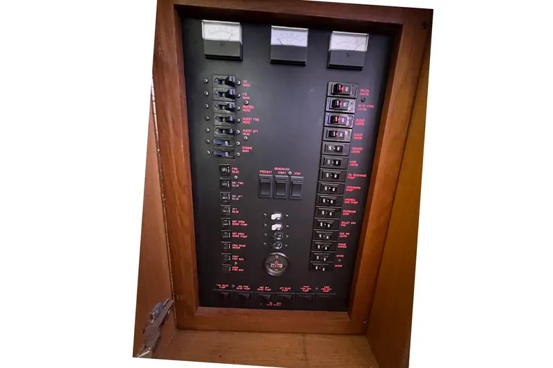 Slide: The Image of Electrical panel of a 2002 Ocean Yachts 56 Super Sport boat, featuring switches and gauges. - 34
