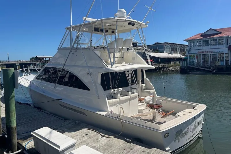 Slide: The Image of 2002 Ocean Yachts 56 Super Sport docked at marina under clear blue sky. - 4