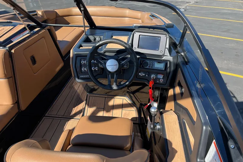 Slide: The Image of 2022 Moomba Makai boat interior with steering wheel and control panel. - 10