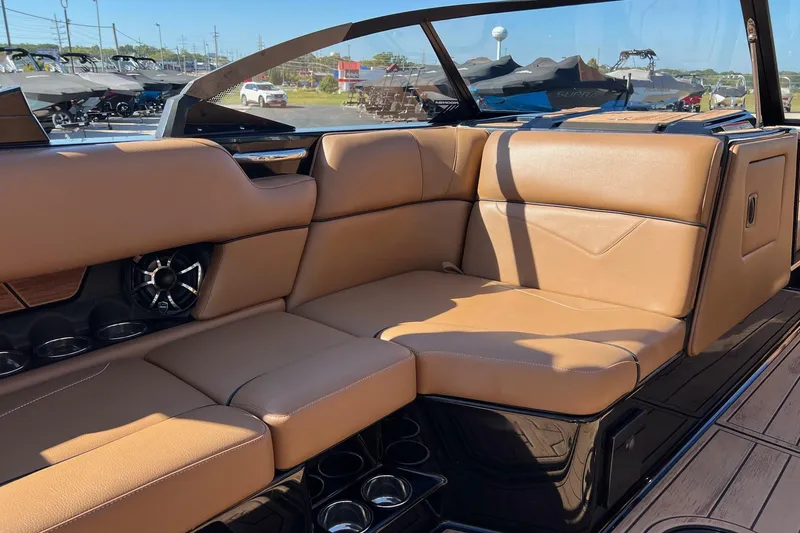 Slide: The Image of Luxurious tan seating in 2022 Moomba Makai boat, featuring cup holders and speaker system. - 11