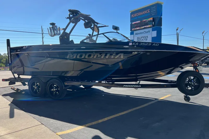 Slide: The Image of 2022 Moomba Makai boat on trailer at dealership, showcasing sleek design and modern features. - 5