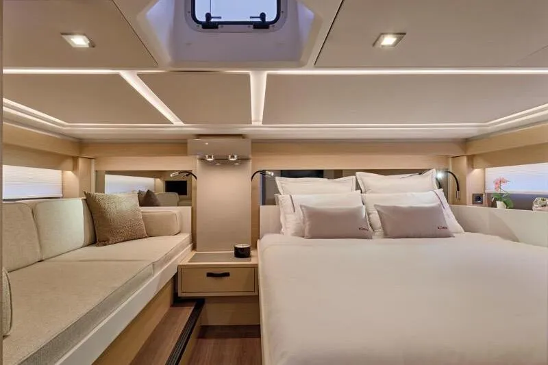 Slide: The Image of Luxurious interior of 2026 Jeanneau DB 43 yacht with elegant bedding and seating. - 11