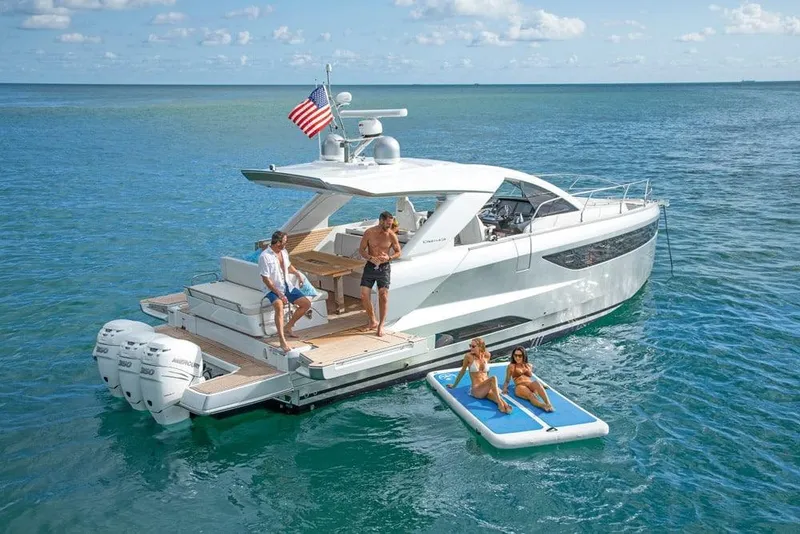 Slide: The Image of 2026 Jeanneau DB 43 yacht on open water with people enjoying leisure activities. - 3