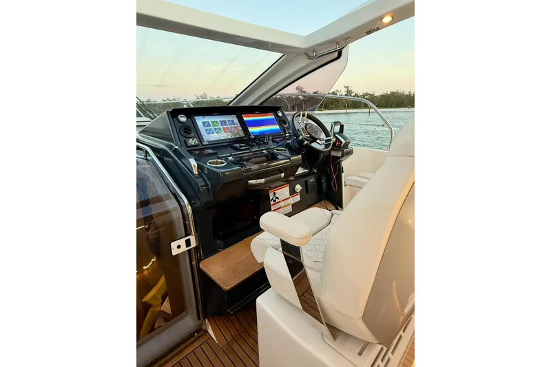 Slide: The Image of Helm of 2026 Jeanneau DB 43 yacht with modern navigation equipment and luxurious seating. - 5