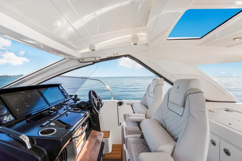 Slide: The Image of Interior of 2026 Jeanneau DB 43 yacht with luxurious seating and modern dashboard. - 6