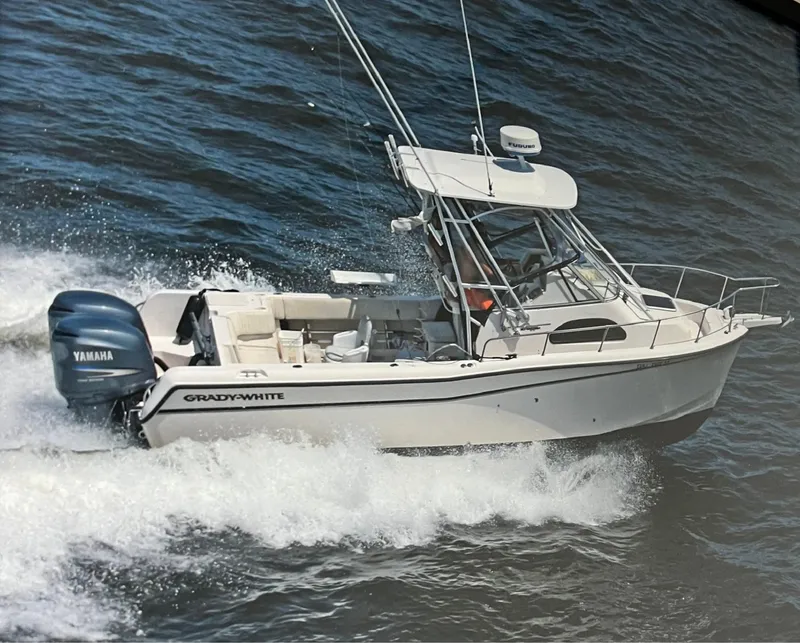 Slide: The Image of 2003 Grady-White 282 Sailfish WA boat cruising on water with Yamaha engines. - 1