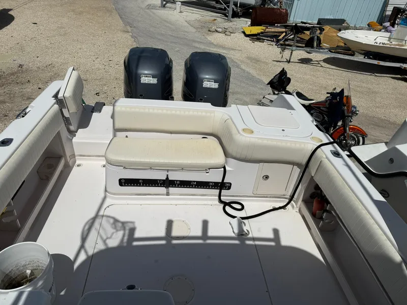Slide: The Image of 2003 Grady-White Sailfish 282 boat interior with seating and dual outboard motors. - 10