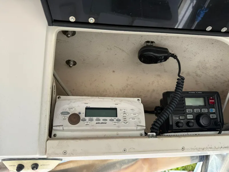 Slide: The Image of 2003 Grady-White Sailfish 282 boat radio and control panel in storage compartment. - 13