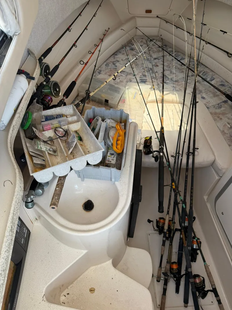 Slide: The Image of Interior of 2003 Grady-White Sailfish 282 with fishing gear and rods organized neatly. - 14
