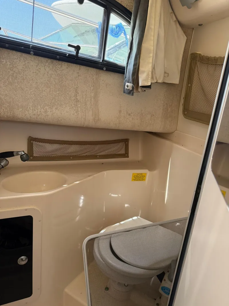 Slide: The Image of 2003 Grady-White Sailfish 282 boat bathroom with toilet and sink. - 15
