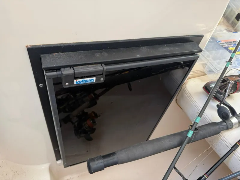 Slide: The Image of 2003 Grady-White Sailfish 282 boat interior with fishing rods and storage compartment. - 16