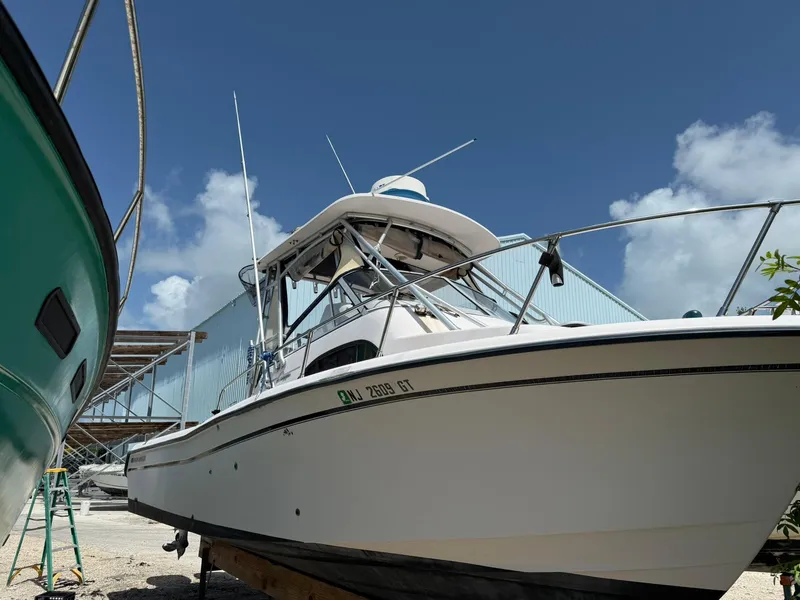 Slide: The Image of 2003 Grady-White Sailfish 282 boat on land under clear blue sky. - 20