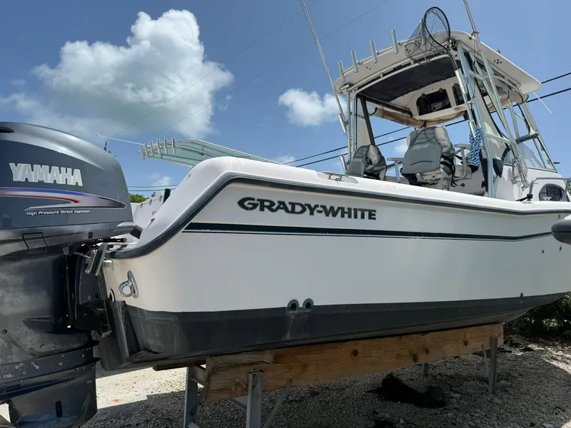 Slide: The Image of 2003 Grady-White Sailfish 282 boat on display, featuring dual outboard motors. - 4