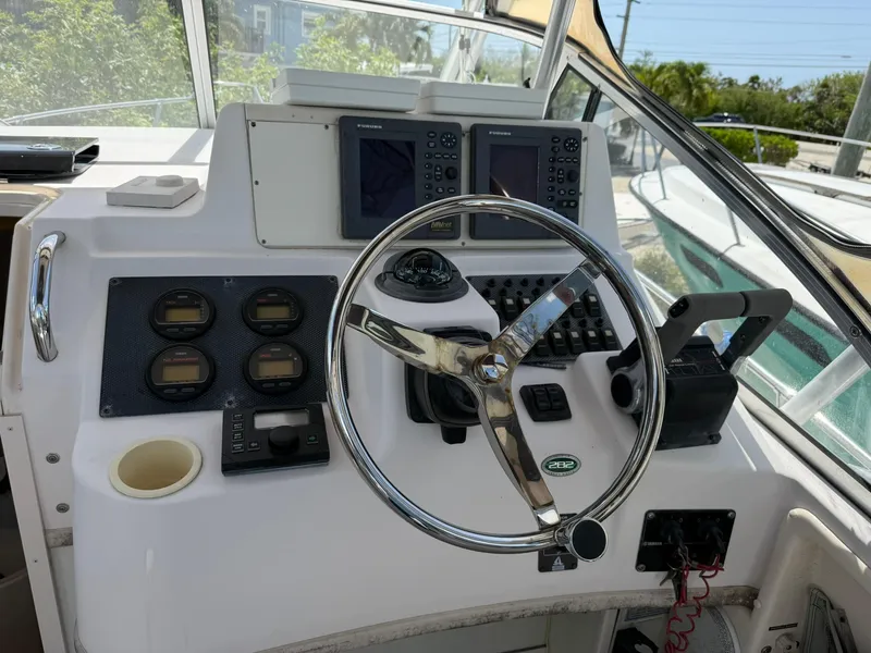 Slide: The Image of Helm of 2003 Grady-White Sailfish 282 with steering wheel and navigation instruments. - 6