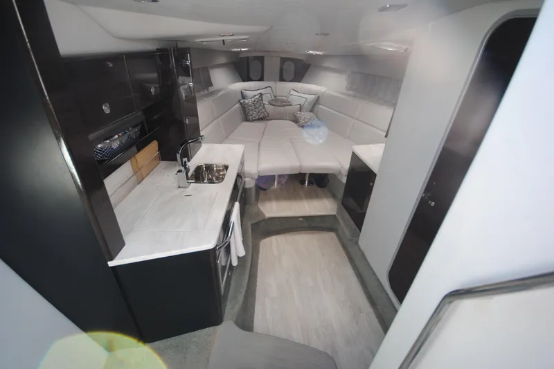 Slide: The Image of 2017 Formula 370 Super Sport boat interior with white seating and open storage compartments. - 11