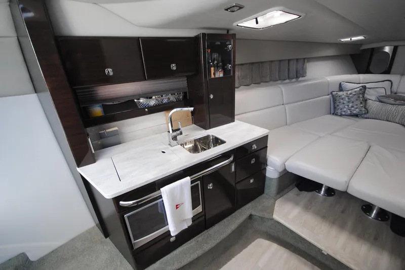 Slide: The Image of 2017 Formula 370 Super Sport interior with modern kitchen and cozy seating area. - 13