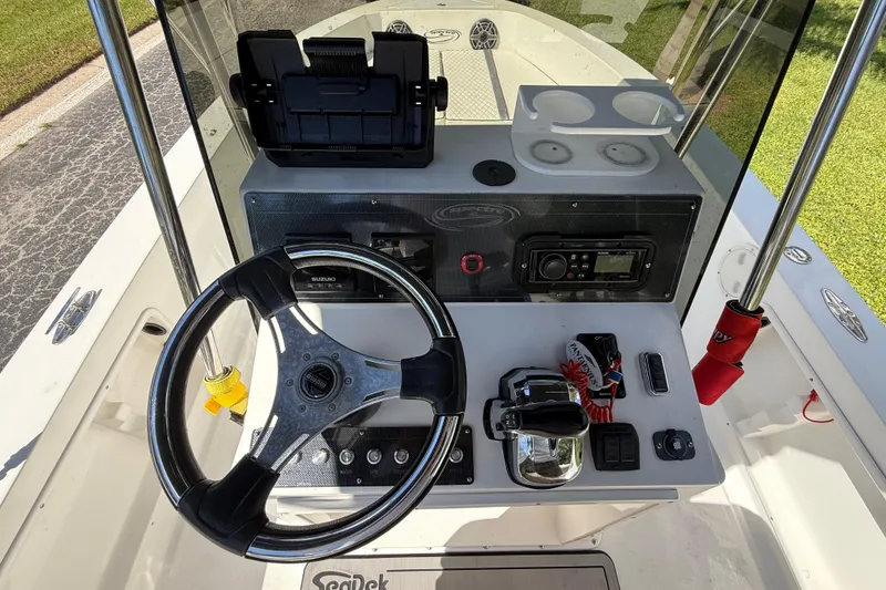 Slide: The Image of Steering console of a 2002 Spectre 22CC boat with controls and navigation equipment. - 9