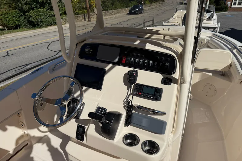 Slide: The Image of 2018 Grady-White Fisherman 216 boat console with steering wheel and navigation controls. - 4