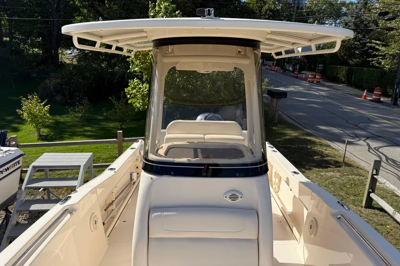 Slide: The Image of 2018 Grady-White Fisherman 216 boat, view of helm and seating area, parked outdoors. - 5