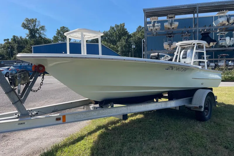 Slide: The Image of 2006 Chaos 16 Bonefish boat on trailer, parked outdoors near storage facility. - 0