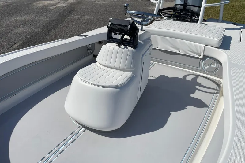 Slide: The Image of 2006 Chaos 16 Bonefish boat interior with white seating and steering console. - 10