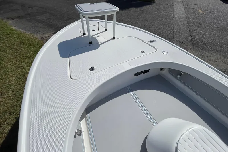 Slide: The Image of 2006 Chaos 16 Bonefish boat deck with seating and storage compartments. - 12