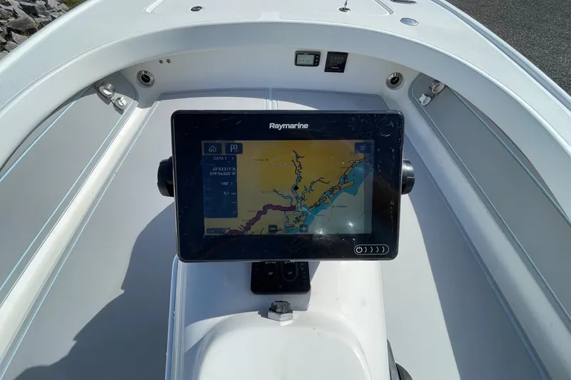Slide: The Image of 2006 Chaos 16 Bonefish boat with Raymarine navigation display showing a detailed map. - 14