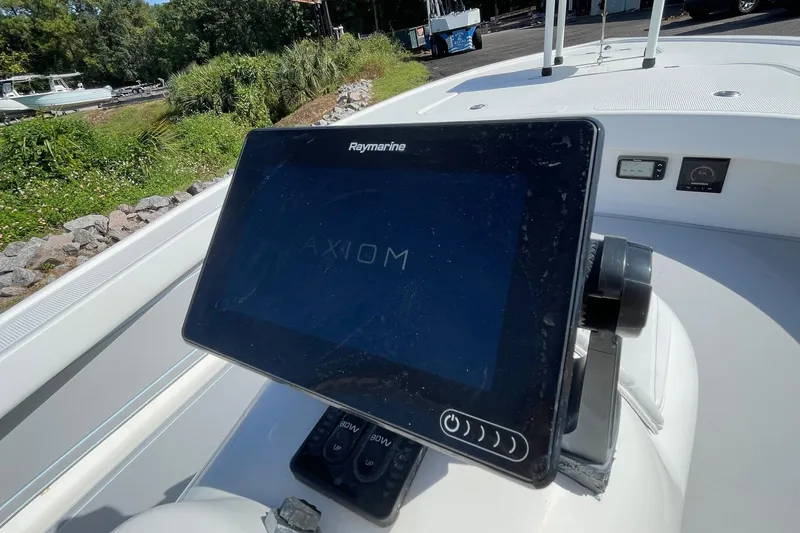 Slide: The Image of Raymarine Axiom display on 2006 Chaos 16 Bonefish boat, docked outdoors. - 15