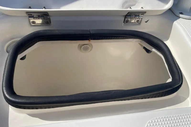 Slide: The Image of Open storage compartment on a 2006 Chaos 16 Bonefish boat. - 21