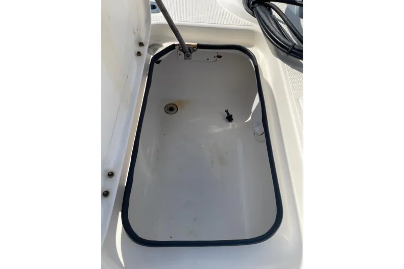 Slide: The Image of Open storage compartment in 2006 Chaos 16 Bonefish boat, showing interior details. - 22