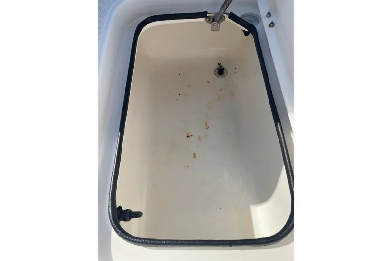 Slide: The Image of Open storage compartment in 2006 Chaos 16 Bonefish boat, showing interior details. - 23