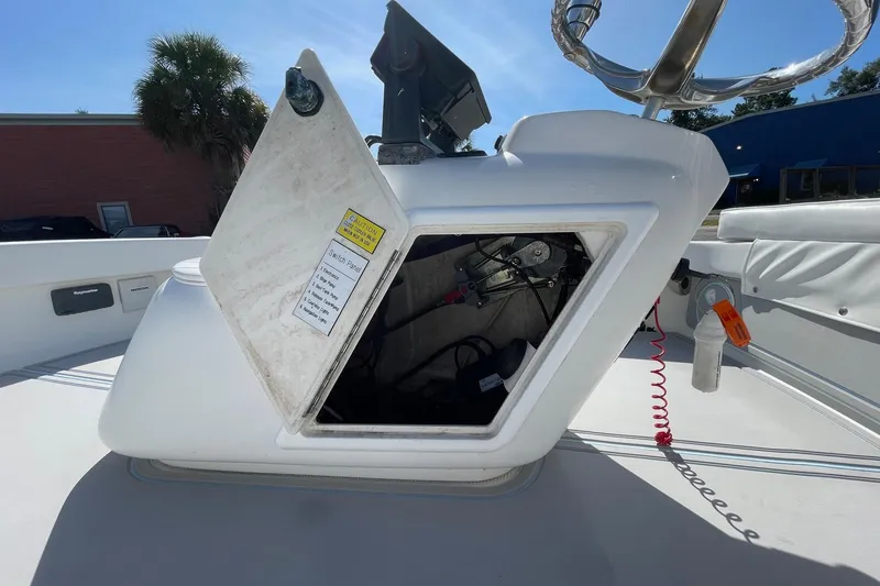 Slide: The Image of 2006 Chaos 16 Bonefish boat console with open storage compartment and visible wiring. - 24