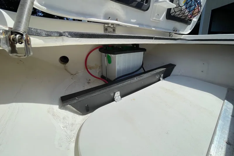 Slide: The Image of 2006 Chaos 16 Bonefish boat battery compartment with wiring and storage. - 28