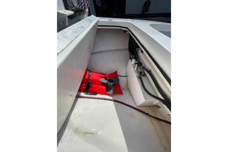 Slide: The Image of 2006 Chaos 16 Bonefish boat interior with red life jacket and propeller. - 29