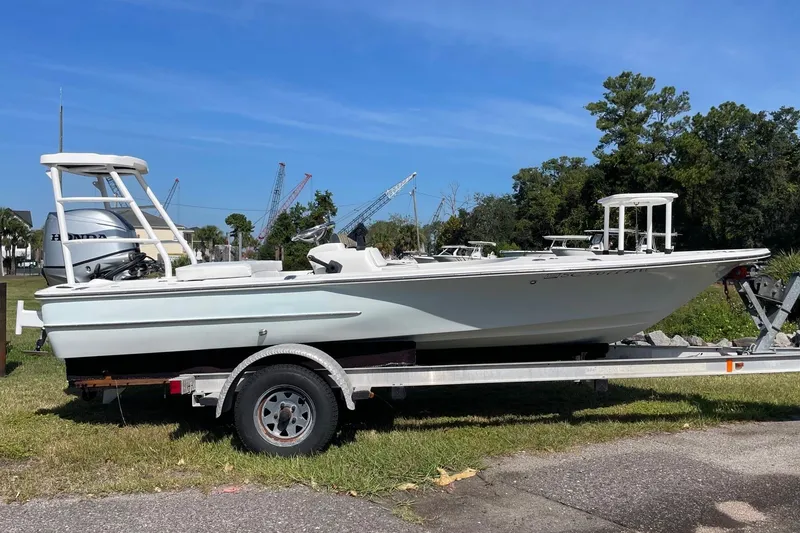 Slide: The Image of 2006 Chaos 16 Bonefish boat on trailer, parked outdoors with clear sky background. - 3