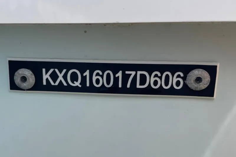 Slide: The Image of HIN plate on 2006 Chaos 16 Bonefish boat, displaying serial number KXQ16017D606. - 32