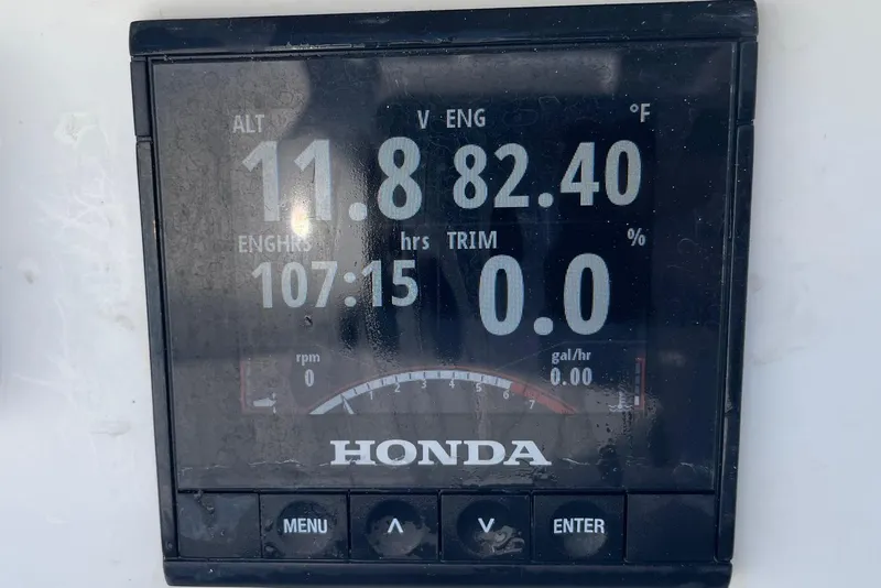 Slide: The Image of Honda engine display showing 11.8 volts, 82.4°F, 107:15 engine hours on Chaos 16 Bonefish. - 34