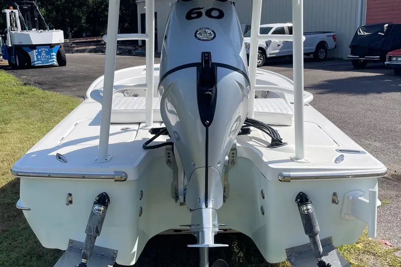 Slide: The Image of 2006 Chaos 16 Bonefish boat with outboard motor, parked outdoors. - 35