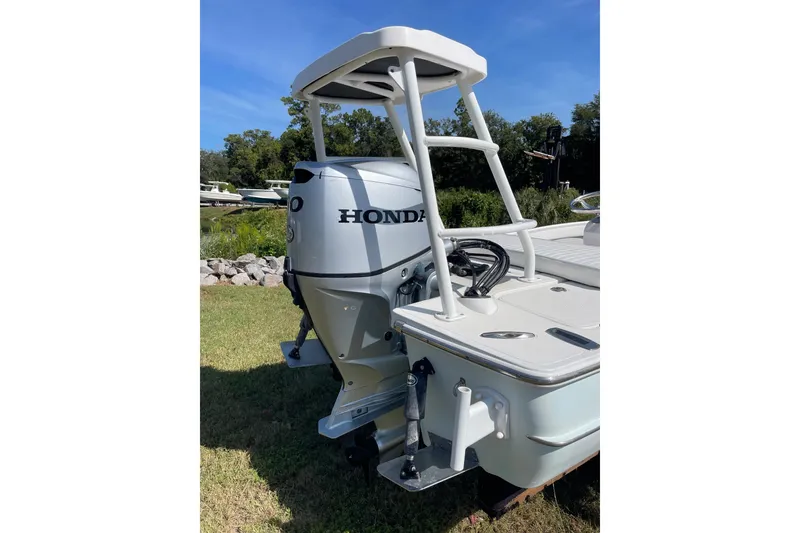 Slide: The Image of 2006 Chaos 16 Bonefish boat with Honda outboard motor, parked on grass. - 36