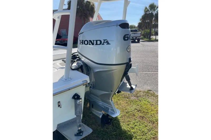 Slide: The Image of 2006 Chaos 16 Bonefish boat with Honda 60 outboard motor, parked outdoors. - 37
