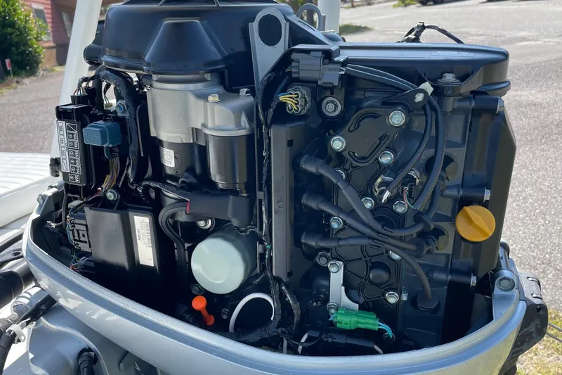 Slide: The Image of Close-up of a 2006 Chaos 16 Bonefish boat engine, showcasing intricate wiring and components. - 39