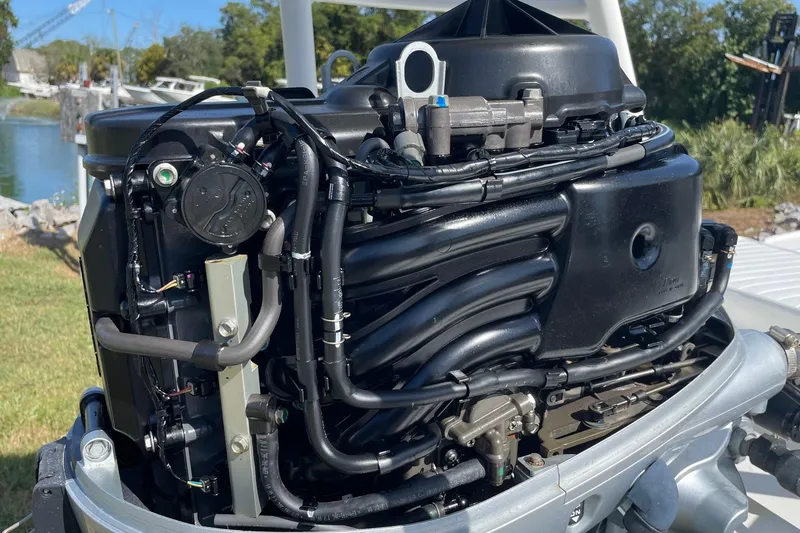 Slide: The Image of 2006 Chaos 16 Bonefish boat engine, detailed view with surrounding outdoor setting. - 40